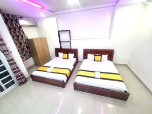 two twin beds in a room with a window at 158A Hotel in Ho Chi Minh City +42 photos