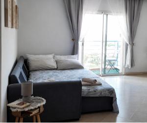 a bed in a room with a couch and a window at Buenavista CaboNegro in Cabo Negro +39 photos
