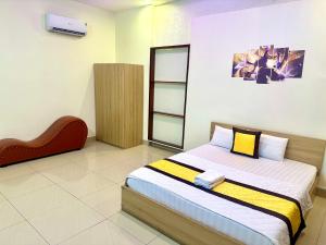 a bedroom with a bed and a chair in it at 158A Hotel in Ho Chi Minh City