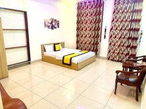 a bedroom with a bed and a table and chairs at 158A Hotel in Ho Chi Minh City