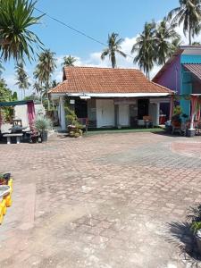 a house with a tile roof and palm trees at Asni chalet in Marang