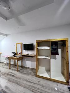 a room with a desk and a computer on a wall at Asni chalet in Marang