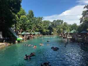 a group of people in a pool at a water park at S&L Lodging House and Tampisaw Restaurant in Pandan +21 photos