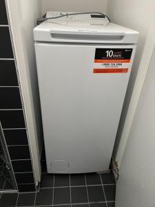 a small white refrigerator with a sign on it at Landhaus Mathilda - Kurort Gohrisch - Kamin - Terrasse - Gartensauna - Parkplatz in Papstdorf