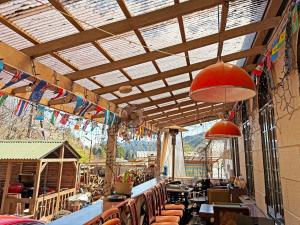 a restaurant with tables and chairs and a ceiling at Nikko Park Lodge Mountain Side in Nikko