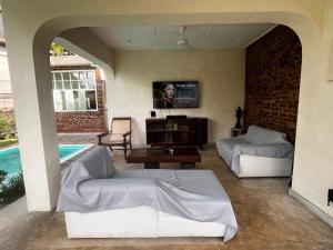 a living room with two couches and a pool at BnB by Month in Weligama