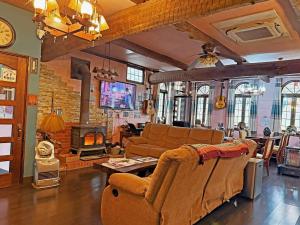 a living room with a couch and a fireplace at Nikko Park Lodge Mountain Side in Nikko
