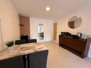 a kitchen and dining room with a table and a mirror at RA Suites in Tijuana