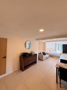 a large living room with a bed and a table at RA Suites in Tijuana