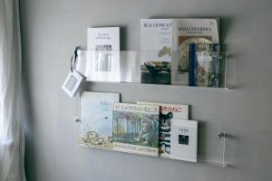 a book shelf with books on a wall at 青梅駅3分OME桜梅庵omean tinyhouse designers hideaway in Ome
