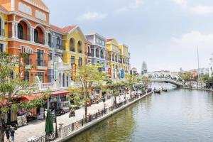 a river in a city with buildings and a bridge at Thai Thinh Hotel Grand World in Phú Quốc