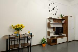 a living room with a table and a refrigerator at Студія біля Університету in Chernivtsi +16 photos