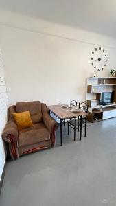 a living room with a couch and a table at Студія біля Університету in Chernivtsi
