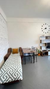 a living room with a couch and a dining room table at Студія біля Університету in Chernivtsi
