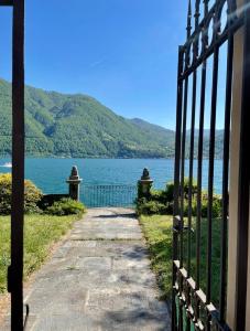 a gate with a view of a body of water at Lakeside Paradise Porlezza in Cima