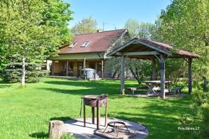 a park with a picnic shelter and a picnic table at Viesu māja "Ozoliņi" in Jūrkalne