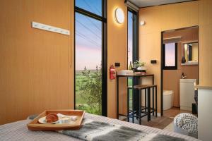 a bedroom with a bed with a tray of food on it at Belrose Estate by Tiny Away in Dumbalk