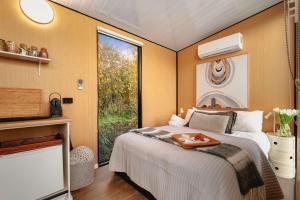 a bedroom with a bed with a tray on it at Belrose Estate by Tiny Away in Dumbalk +15 photos