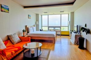 a living room with a bed and a couch at Cozy - Sunny Studio in Incheon