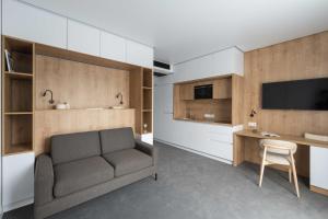 a living room with a couch and a desk at Lumen Living in Kyiv