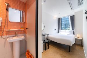 a hotel room with a bed and a sink and a mirror at Hotel LETS POP in Seoul +85 photos