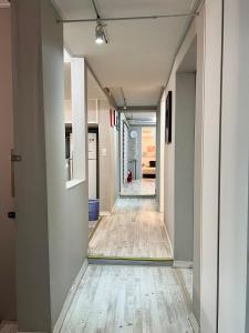 a corridor of an empty hallway with wood floors at Ernie MyeongDon'g Sation 1Min, Anytime Check In in Seoul +27 photos