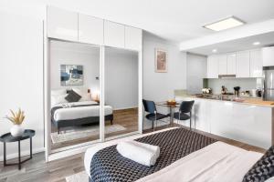 a living room with a bed and a kitchen at 188 Apartments in Perth