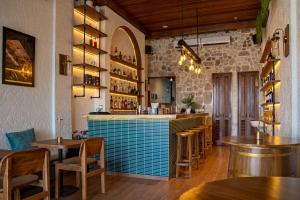 a bar in a restaurant with wooden tables and chairs at Avida Studios in Uluwatu - 5 mins walk to Thomas Beach in Uluwatu