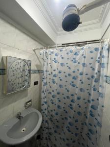 a bathroom with a sink and a shower curtain at Casa Danna in Sucre +25 photos