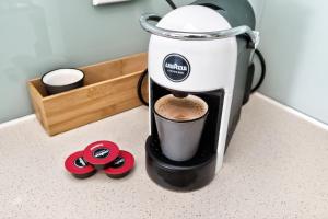 a coffee maker sitting on a counter with a cup at 188 Apartments in Perth