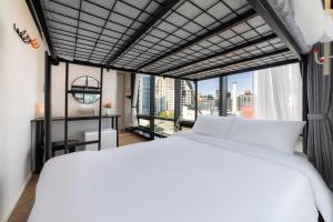 a bedroom with two beds and a large window at Hotel LETS POP in Seoul