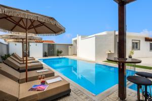 a swimming pool in a backyard with a house at Pervolia House Private Pool Near Airport in Kremasti