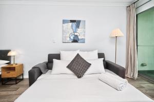 a bedroom with a large bed with white pillows at 188 Apartments in Perth