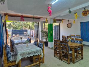 a dining room with a table and chairs at Teresita Home JKIA in Nairobi