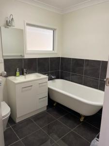 a bathroom with a tub and a sink and a toilet at Salt and Sea-renity in Russell Island