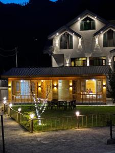 a house with lights in front of it at night at Dream River Resort in Batakūt
