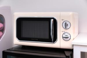 a microwave oven sitting on top of a table at Hotel LETS POP in Seoul