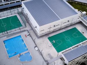 an overhead view of three tennis courts on a building at Aariz Homestay in Malacca +7 photos