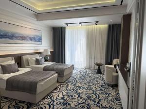 a hotel room with two beds and a couch at Mustafa Hotel in Samarkand +81 photos