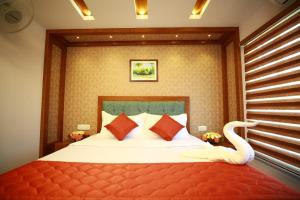 a bedroom with a bed with a swan on it at Hills & Cruise Luxury Houseboats in Alleppey