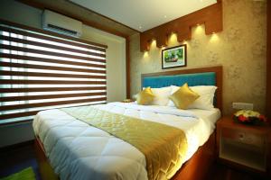 a bedroom with a large bed and a window at Hills & Cruise Luxury Houseboats in Alleppey