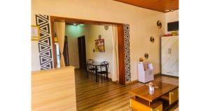 a living room with a table and a dining room at Breeze House Hotel in Kigali