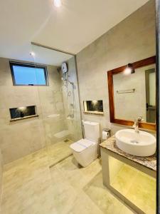 a bathroom with a toilet and a sink and a shower at Srilak View Holiday Inn in Haputale +89 photos