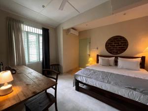 a bedroom with a bed and a wooden table at BnB by Month in Weligama +50 photos