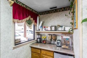 a small kitchen with a counter and a window at Rodeway Inn Goodlettsville South in Goodlettsville +28 photos