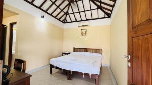 ein Schlafzimmer mit einem Bett in einem Zimmer in der Unterkunft Stopover Muziris in Kodungallūr + 34 Fotos