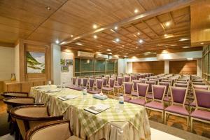 a conference room with tables and purple chairs at Well Park Residence in Chittagong