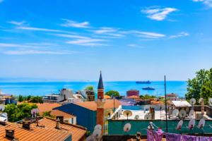 a cityscape of a city with roofs and a blue sky at Kadirga Antik Hotel - Sultanahmet in Istanbul +43 photos