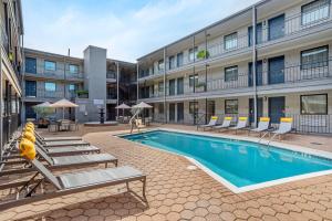 a swimming pool in front of a building at Country Inn & Suites by Radisson, Metairie New Orleans , LA in Metairie