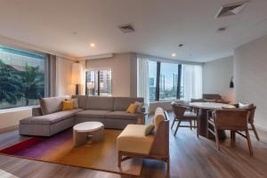 a living room with a couch and a table at Radisson Hotel Trinidad in Port-of-Spain